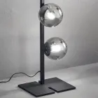 Moderne vloerlamp van zwart of goudkleurig metaal en geblazen glas - Birga Viadurini