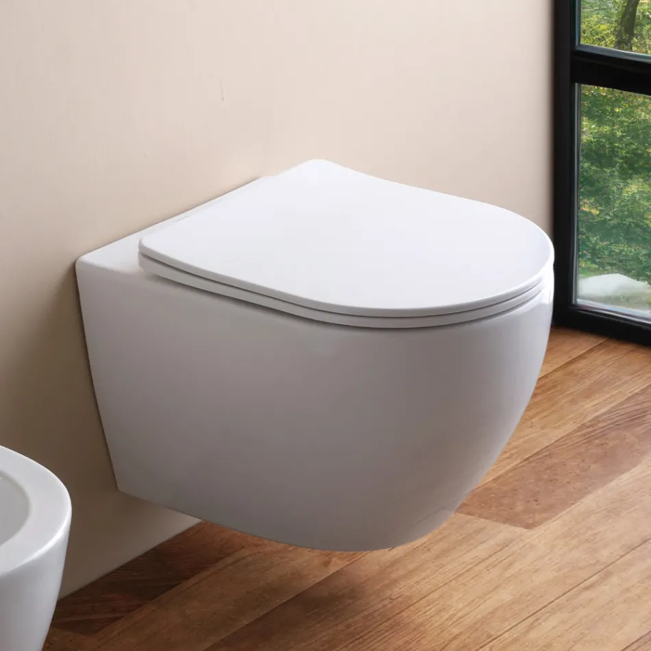 Wandgemonteerd randloos toilet met soft-close keramische zitting - Juniper   Viadurini
